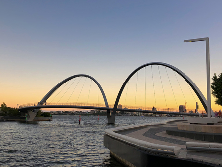 PERTH, AUSTRALIA - FEBRUARY 2018 : People walking on Elizabeth Quay pedestrian bridge at Central Business District (CBD) in evening in Perth, Australia on February 24, 2018. It is leaning-arch bridge.のeditorial素材