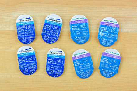 BANGKOK, THAILAND - APRIL 2018 : Bausch & Lomb SofLens Monthly and Daily disposable soft Contact Lenses with Aspheric Optics on wooden background on April 09, 2018 in Bangkok, Thailandのeditorial素材