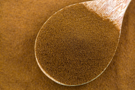 Pure instant African spray dried coffee from Robusta and Arabica coffee beans in wooden spoon, top...
