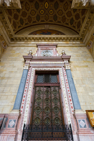 BUDAPEST, HUNGARY - JULY 2018 : Medallions on wooden door showing busts of the 12 apostles at St. Stephen's Basilica in Budapest, Hungary on July 18, 2018.のeditorial素材