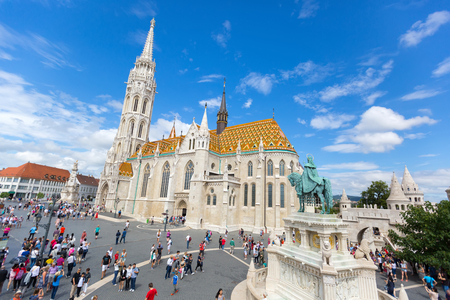 BUDAPEST, HUNGARY - JULY 2018 : People walking near equestrian statue of St Stephen, first king of Hungary, in front of Matthias Church, Castle Hill, Budapest, Hungary on July 19, 2018のeditorial素材