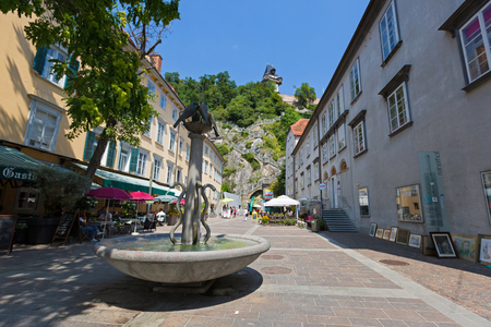 GRAZ, AUSTRIA - JULY 2018 : Fountain on Schlossbergplatz with background of staircase going up to Schlossberg Castle Hill in Graz, Austria on July 20, 2018.のeditorial素材