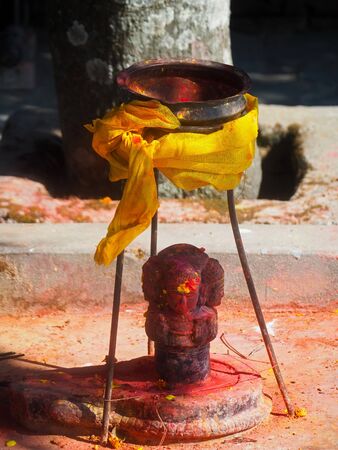 Shrine covered in vermillion to worship Goddess Kali. Red pigment powder on statue, part of Kali Shrine on the mountain in Dhulikhel, Nepalの写真素材