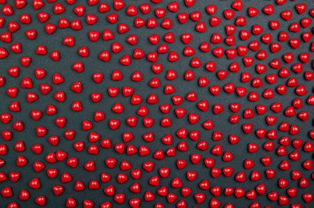 Red cinnimon candy hearts for valentine's day on a dark backgroundの写真素材