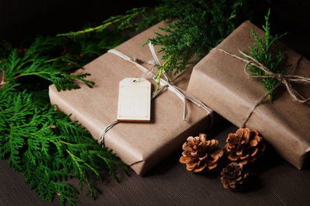 Brown paper packages tied up with string with Christmas greeneryの写真素材