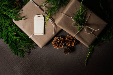 Brown paper packages tied up with string with Christmas greenery