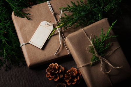 Brown paper packages tied up with string with Christmas greeneryの写真素材