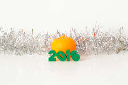Inscription green figures candle Mandarin shiny tinsel on a white background 2016