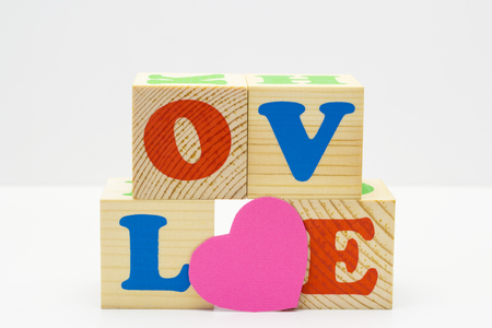 Wood cube with inscription LOVE isolated on a white backgroundの写真素材
