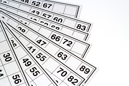 Wooden kegs and cards  for lotto or bingo game on white backgroundの写真素材