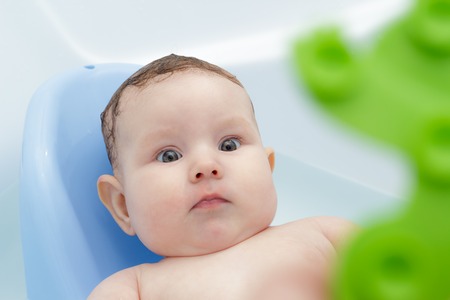 Newborn baby bathe and swim in a large tub