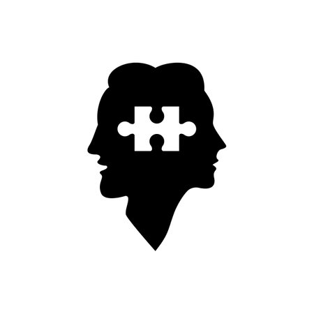 Silhouettes of the head of a man and a woman with a puzzle.のイラスト素材