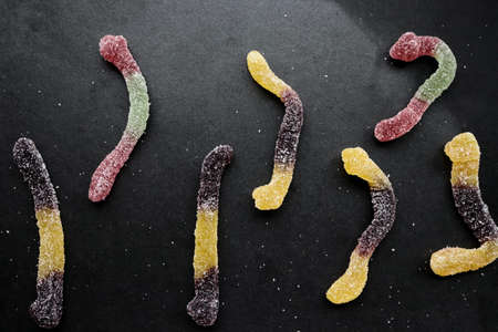 Assorted gummy candies on black background. Top view.の写真素材