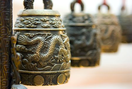 Four antique tibet bells with illustrated dragonの写真素材