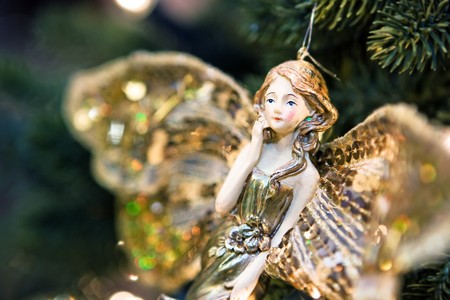 Beautiful handmade angel toy on new year treeの写真素材