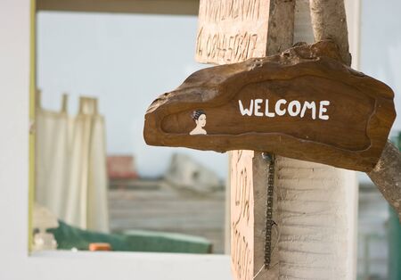 Welcome message on the wood plate near the houseの写真素材