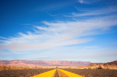 Asphalt road from low angle with mountains on background