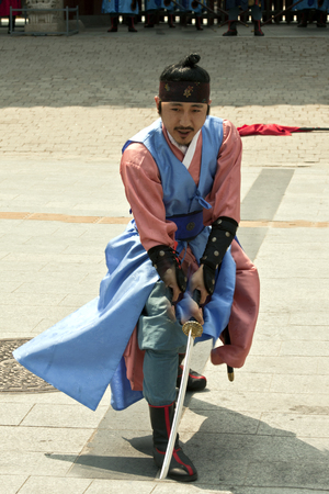 SEOUL, KOREA - MAY 14, 2015:  Armed guards in traditional costume guard the entry gate at Deoksugung Palace, a tourist landmark, in Seoul, South Korea on May 14, 2015のeditorial素材