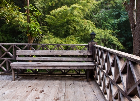 Wooden chair on the porch in the forestの写真素材