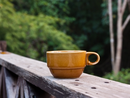 Coffee on balcony fence,The background is a forestの写真素材