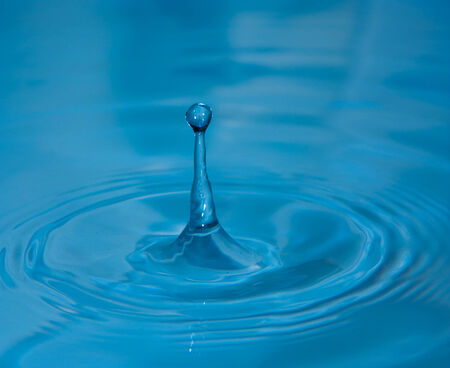 Water drop close up in blue の写真素材
