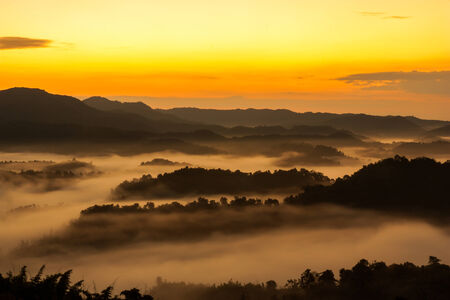 Morning sun landscape with mountains and mist in Thailand.の写真素材
