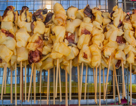 Squid ready for barbecuing in Bangkok, Thailand maket.の写真素材