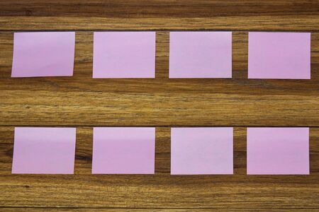 Post-it notes on wooden background.の写真素材