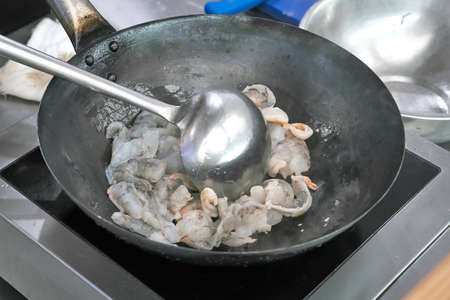 fried shrimp in avocado oil in a frying panの写真素材