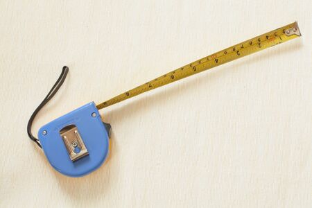 Construction measuring tape on a light background closeup