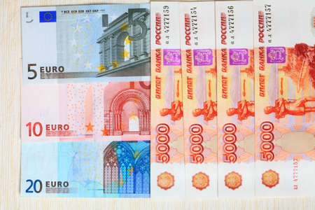 Photo bills of the Russian Federation and the European Union closeup on a light background の写真素材