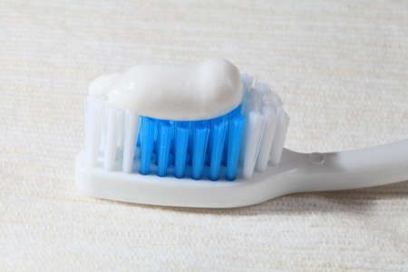 Tooth-brush and paste closeup on a light background 
