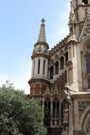 A Catholic Church in Barcelona closeup on the background of blue sky の写真素材