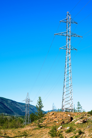 High voltage power lines in mountainous terrainの写真素材