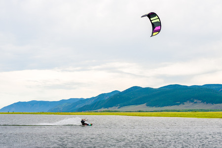 Athlete train by kitesurfing on the lakeの写真素材