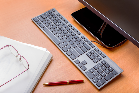Modern office workplace with a wooden tableの写真素材