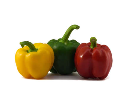 Three fresh peppers: yellow, green, red isolated on white background