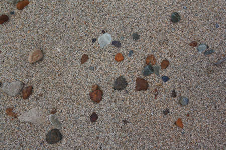 Grains of sand and stones on a beach can be used as background