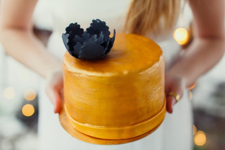A bride and a groom is cutting their wedding cake.の写真素材