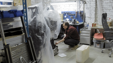 Factory for the production of robots. The engineer examines the robot. Creates a new robot in the...