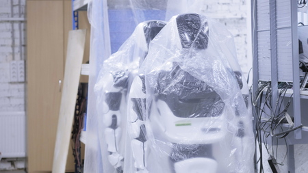 Factory for the production of robots, modern robotic developments. Several robots are in stock in plastic wrapの写真素材