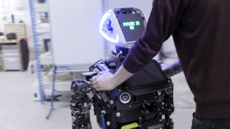 Factory for the production of robots. Engineer moves the robot through the plant. Drives the robot...