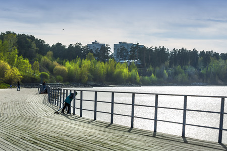 The Berd ' river ( tributary of the Ob ), Berdsk, Novosibirsk oblast, Siberia, Russia - may 10, 2017: a view of the river Wharf and the cityのeditorial素材