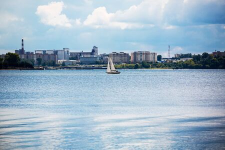 Berdsk, Berdsk Gulf, the river Berd,Novosibirsk oblast, Siberia, Russia - August 19, 2017: yacht in the Gulf of Berdsk in the background the city of Berdskのeditorial素材