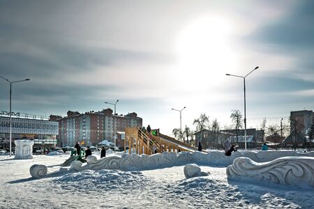 Berdsk, Novosibirsk region, Siberia , Russia-February 18, 2018: winter snow entertainment town with wooden slideのeditorial素材