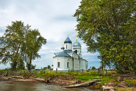 The village of Chingisy, Novosibirsk oblast, Western Siberia,Russia - July 21, 2018: the Orthodox Church of the Holy apostles Peter and Paul on the coast of the Ob riverのeditorial素材