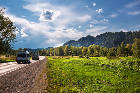 District of Aya Village, Gorny Altai, South Siberia, Russia-August 25, 2018: asphalt road on the background of the Altai mountainsのeditorial素材