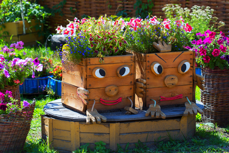 Altai village, Gorny Altai, South Siberia, Russia-August 25, 2018: territory of the arboretum Altai kholmogorie, self-made boxes for street flowersのeditorial素材