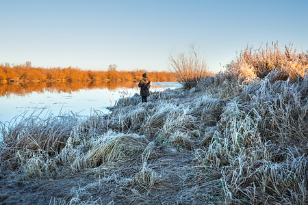 Chik river, Kolyvan district, Novosibirsk region, Western Siberia, Russia-October 27, 2018: fisherman on autumn river fishing spinningのeditorial素材