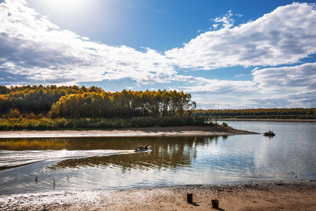 Ob river, Verkh-Suzun, Suzun district, Novosibirsk region, Western Siberia, Russia-September 22, 2018: autumn landscape with fishermen on boatsのeditorial素材